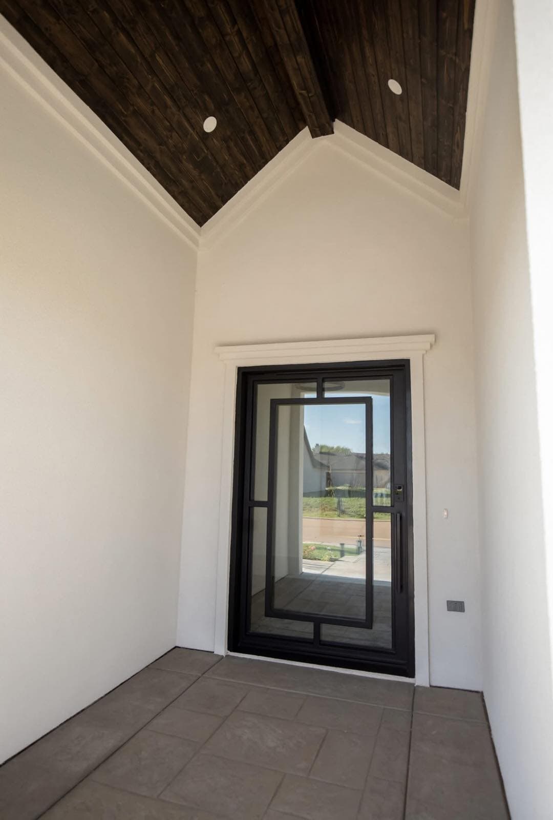 Hand-forged iron entry door installed by Glowmigos